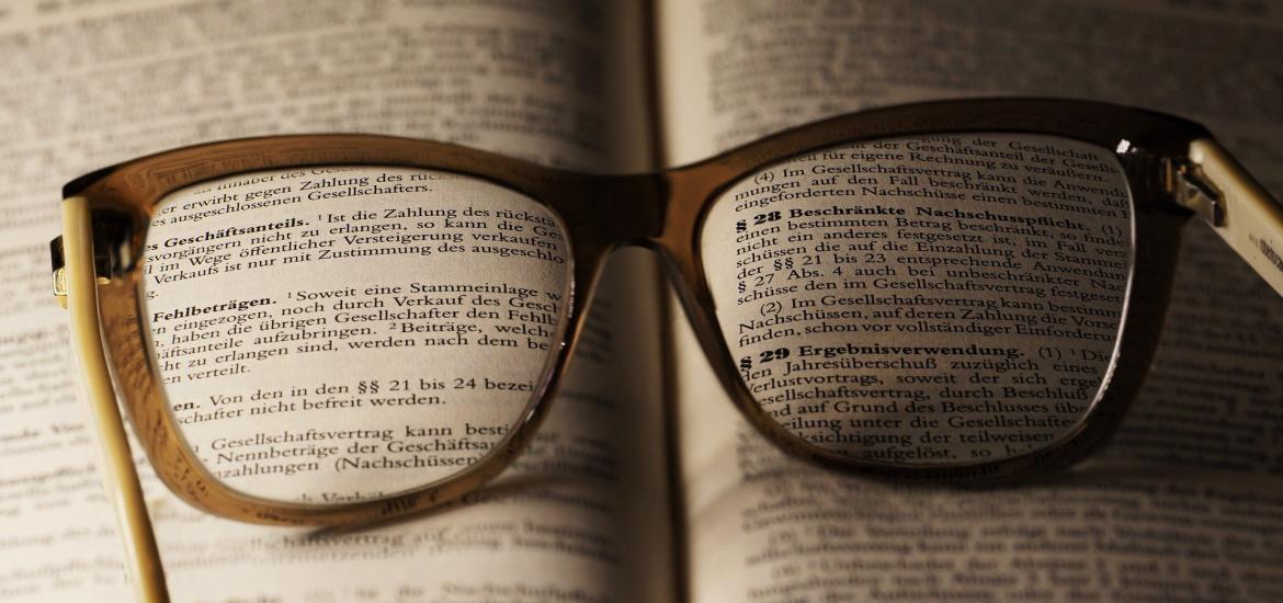 book with a pair of eyeglasses lying on it