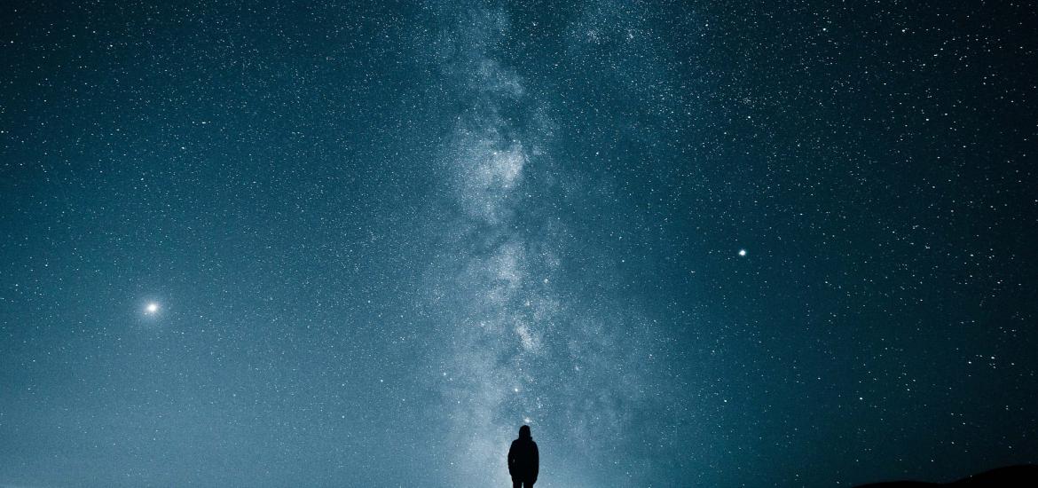 silhouette looking into vast expanse of outer space