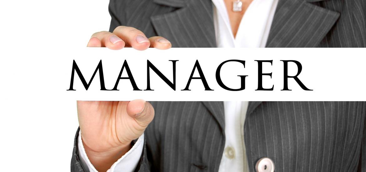 woman holding sign that says Manager